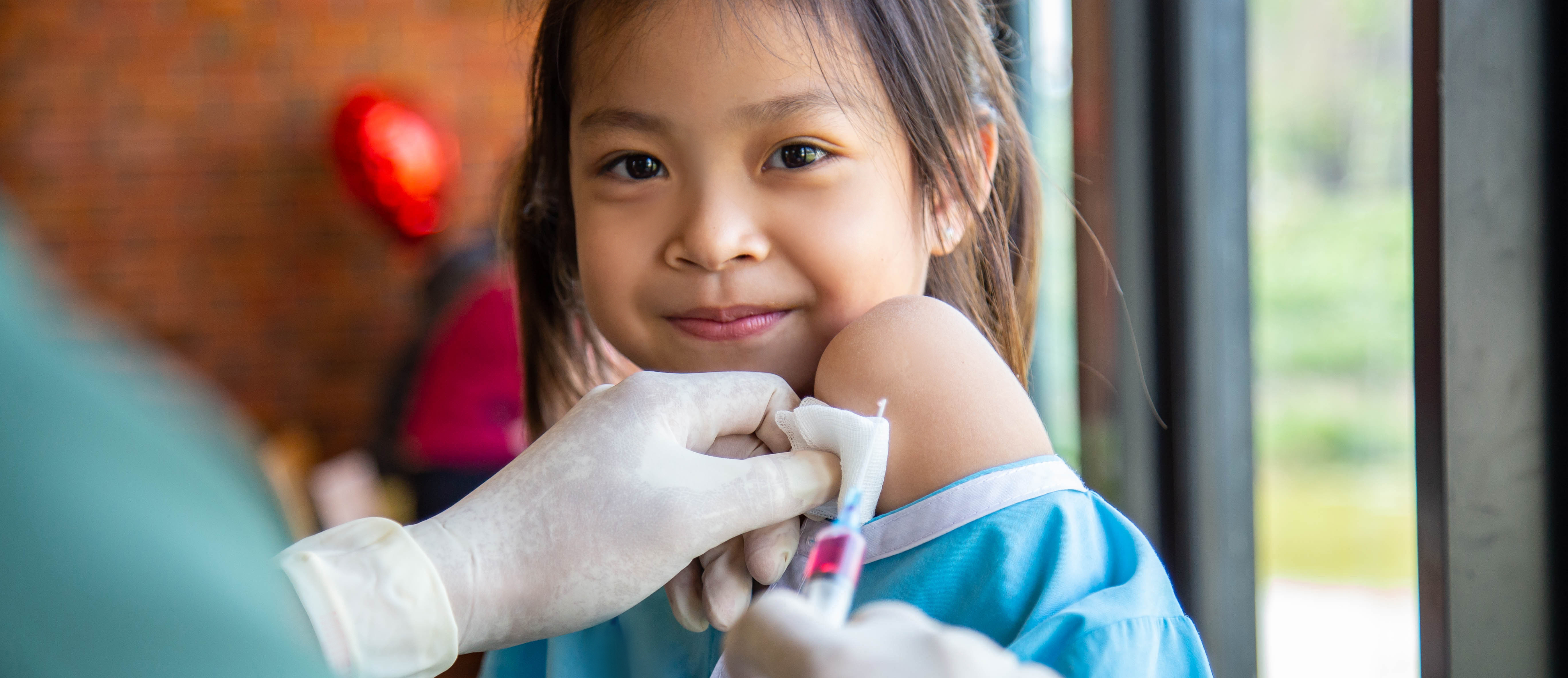 Doctor injection immunization Asian cute girl patient in hospita ...